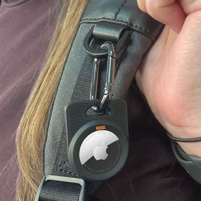 RUGD. Army AirTag Case attached to bag strap, designed for Apple AirTag protection and secure tracking.