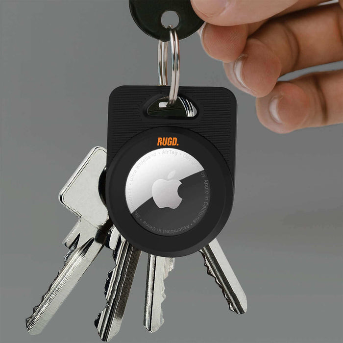 RUGD. Army AirTag Case holding Apple AirTag attached to keys, showcasing ultra-protective design for outdoor activities.