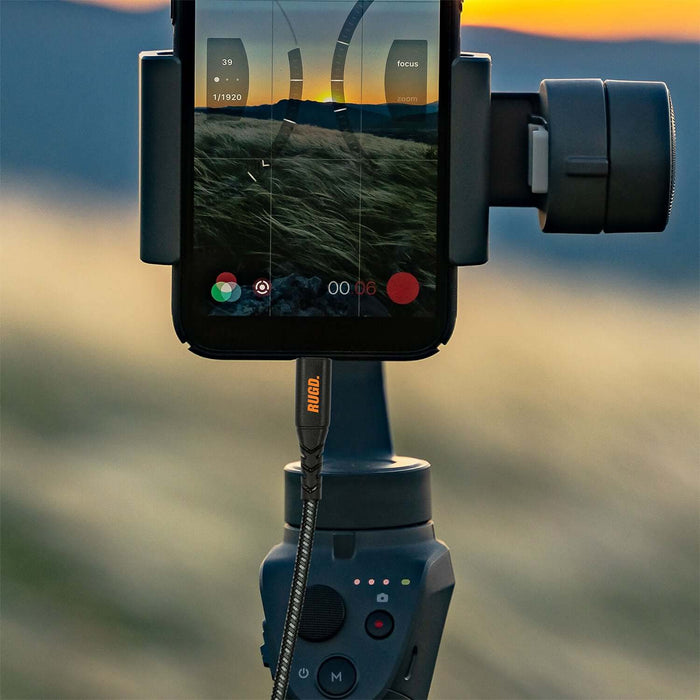Close-up of RUGD. Rhino Power USB-C charging cable connected to a smartphone mounted on a gimbal, perfect for videography.