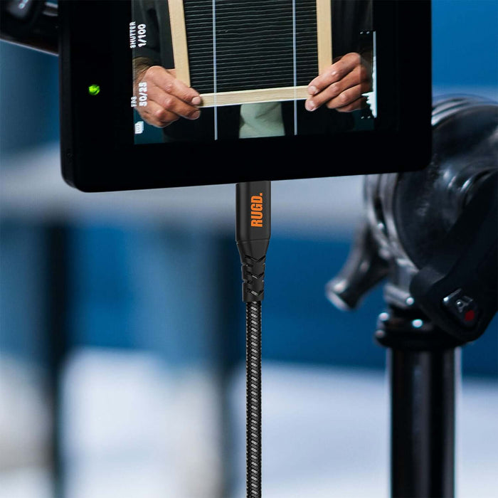 RUGD. Rhino Power USB-C to USB-C charging cable connected to a camera setup, showcasing its durability and strong performance.