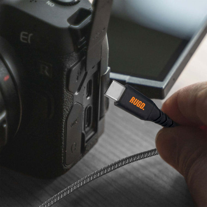 RUGD. Rhino Power USB-C to USB-C charging cable connected to a camera for fast charging and data transfer.