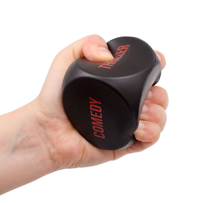 Hand squeezing the Stress Flix Dice Game with 'Comedy' and 'Thriller' labels, perfect for choosing shows and stress relief.