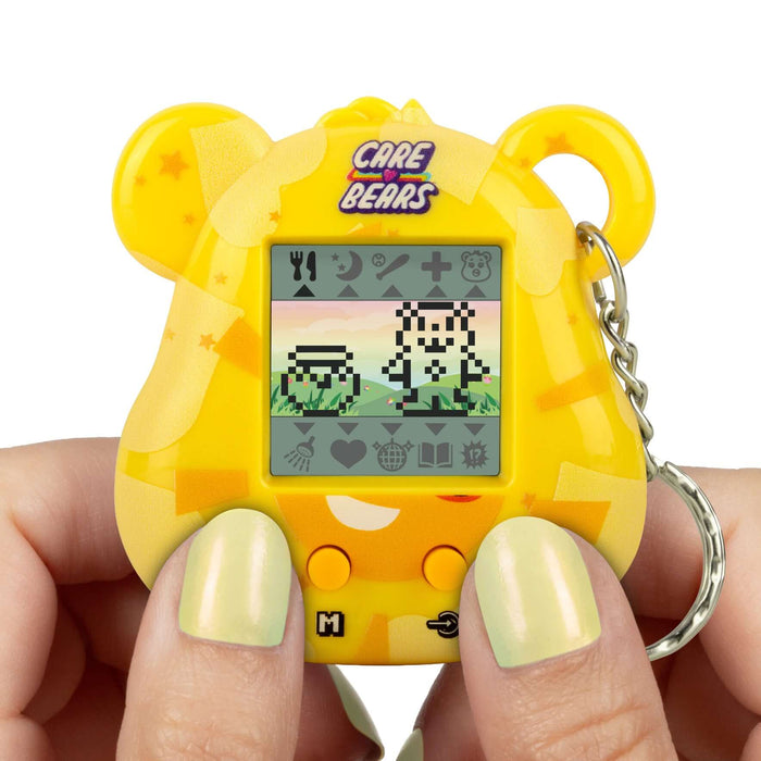 Care Bears Digital Pet device being held, showing fun pixel animations and interactive gameplay on the screen.