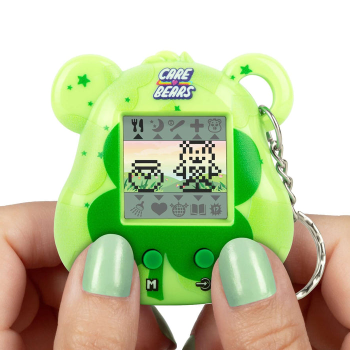 Care Bears Digital Pet in hand, showing interactive gameplay and cute pixel animations on a green bear-shaped device.
