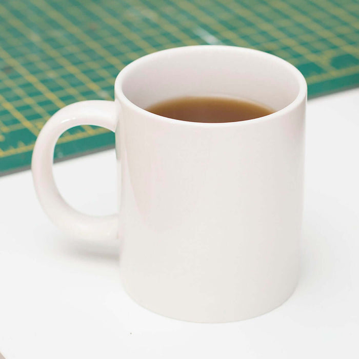 Chewing Gum 'Prank' Mug filled with beverage on a table, showcasing the playful design and hidden gumball chamber.