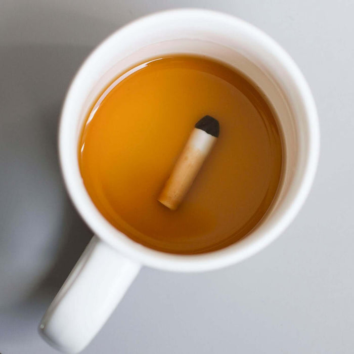 Cigarette 'Prank' Mug with hidden cigarette design revealed in warm drink, perfect for surprising beverage lovers.