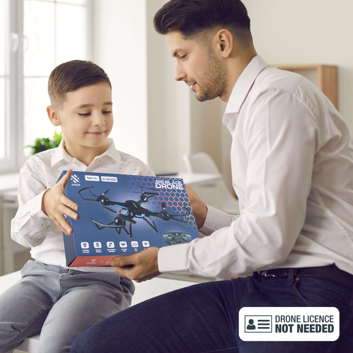 Child receiving the Air Blade Drone box from an adult, showcasing excitement and ease of use.