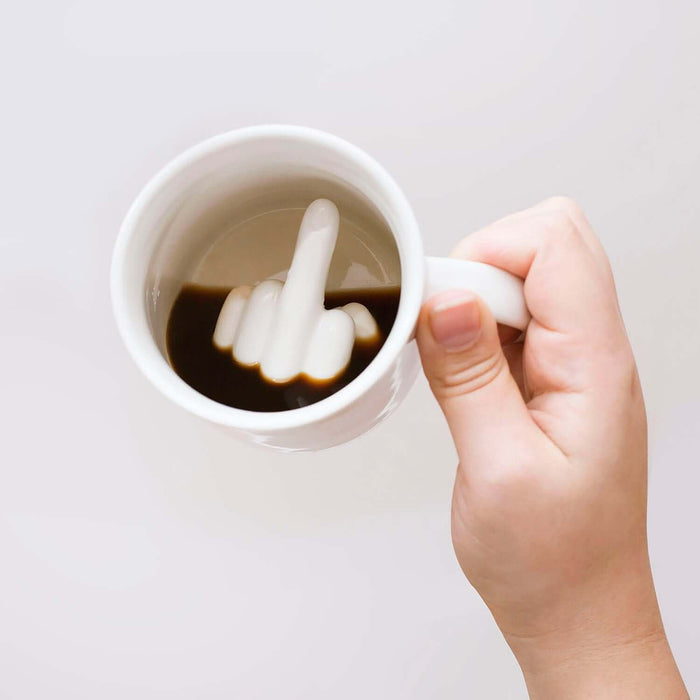 Up Yours 'Prank' Mug held in hand, revealing a cheeky hidden message inside coffee.