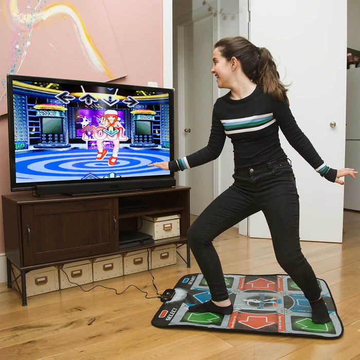 Person dancing on Retro Arcade Dance Mat while playing a dance game on TV