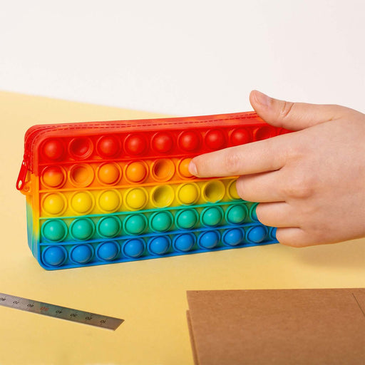 Rainbow Poppit Pencil Case being used for popping fun and stress relief while keeping stationery organized.