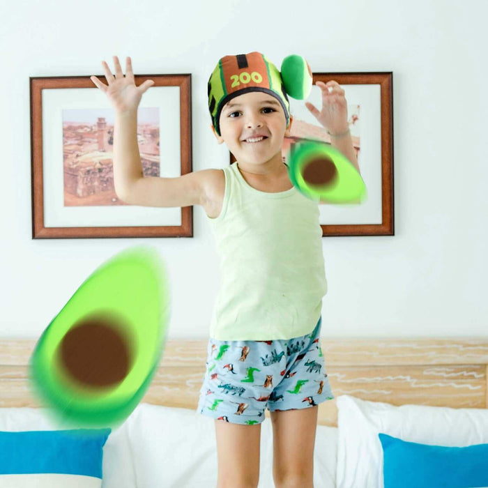 Child enjoying Avo-Catch-O Head Smash Game wearing an avocado hat and throwing Velcro avocado balls.