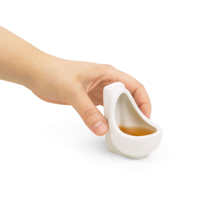 Urinal Shot Glass being held, showcasing unique design for parties and humor.