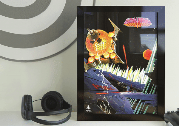 Framed Atari cartridge display featuring classic retro games with the slogan “Futuristic Since Forever,” placed beside black headphones on a modern desk.