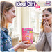 Two friends smiling and exchanging the Care Bears Digital Pet gift, highlighting joy and excitement.