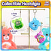 Care Bears Digital Pets on a display, showcasing Good Luck Bear and two collectible keychains, 6 inch and 6.3 inch sizes.