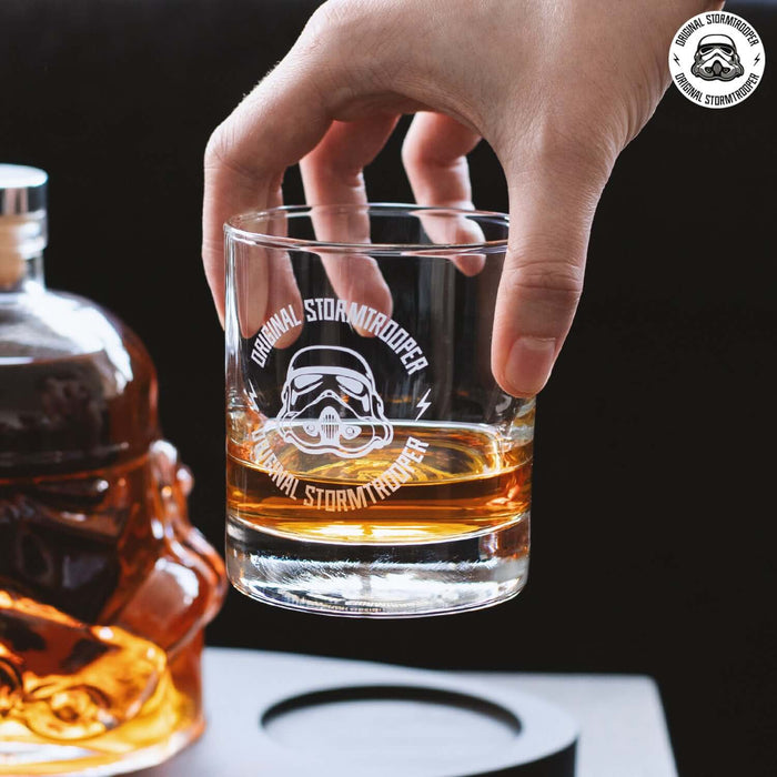 Hand holding a glass from the Original Stormtrooper 3D Helmet Decanter Set with Tray, showcasing detailed Stormtrooper helmet print.