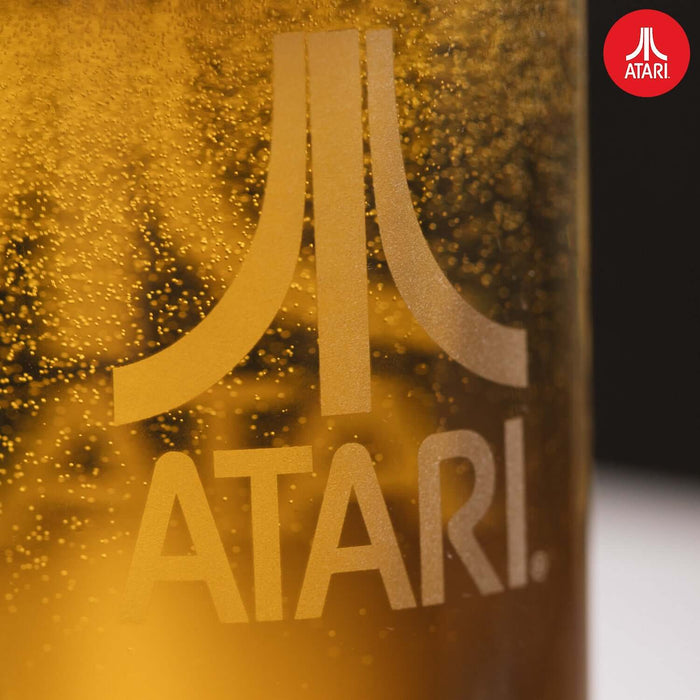 Close-up of Official Atari Beer Glass with iconic Atari emblem, filled with beer. Authentic, heat-resistant Soda-Lime Glass, 1 pint / 600ml.