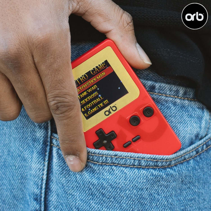 Person placing Orb - Retro Mini Handheld Games Console (150-in-1 Games) in jeans pocket