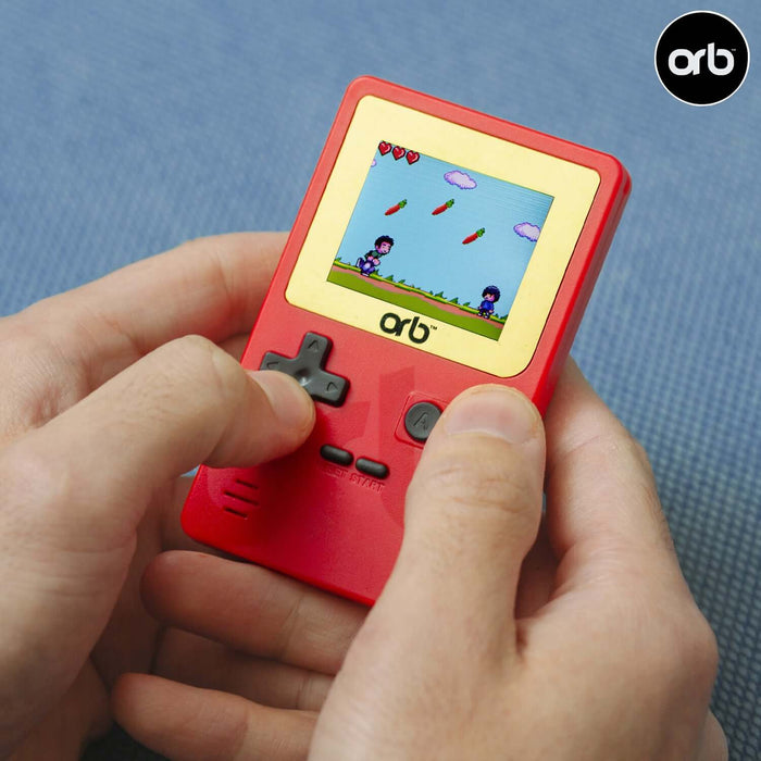 Playing an Orb Retro Mini Handheld Games Console with 150 built-in games on a full-color LCD screen.