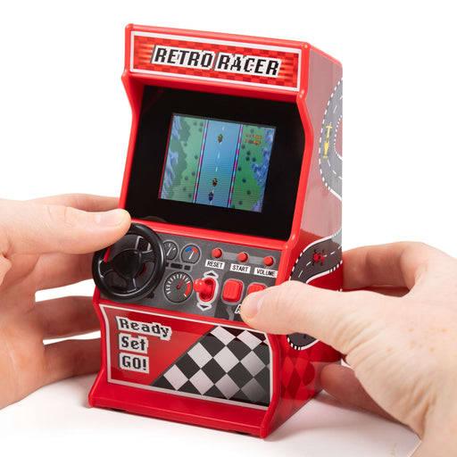 Hands playing Retro Mini Racing Arcade Machine with 30 games, featuring a classic steering wheel and vibrant screen.