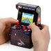 Hands playing the Orb Retro Mini Arcade Machine with vibrant screen showcasing a classic game.