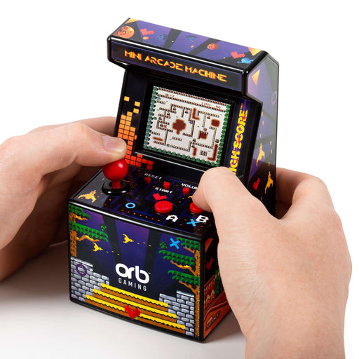 Hands holding the Orb Retro Mini Arcade Machine displaying a classic game on the screen.