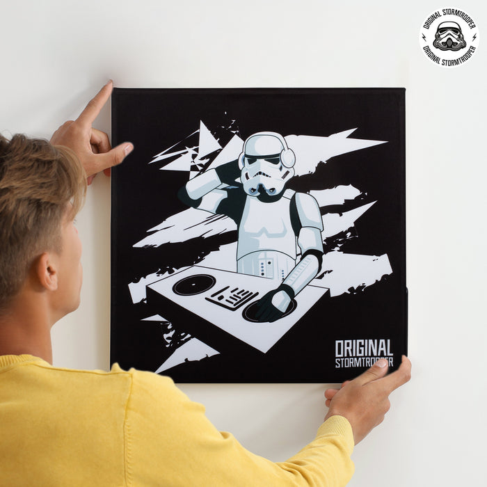 Man hanging Original Stormtrooper Sound Frame, a Bluetooth picture frame speaker with Star Wars DJ design.