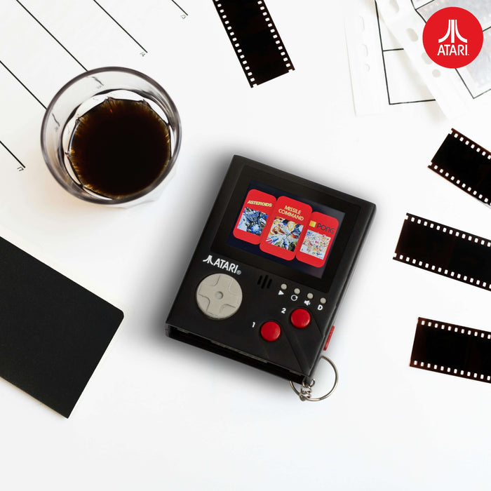 Atari handheld console gaming keyring with 2" LCD screen, featuring iconic games like Pong, Asteroids, and Missile Command.