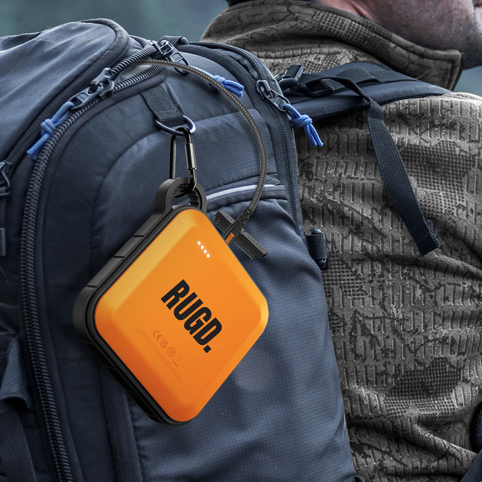 RUGD Power Brick attached to a backpack, showcasing its portable design for outdoor adventures and travel convenience.