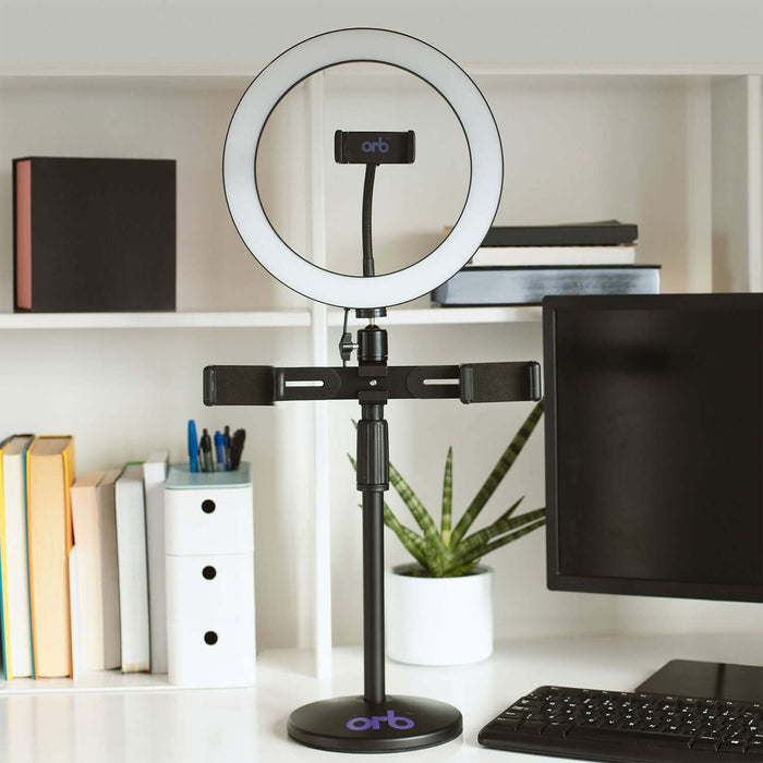 Orb 10" Ring Light Creator Rig on desk with adjustable smartphone holder for content creation and professional lighting.