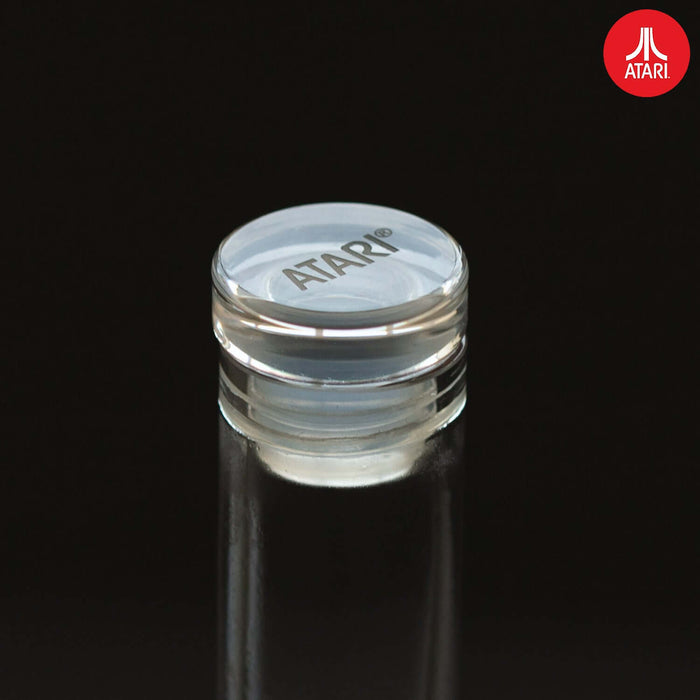 Atari decanter set stopper with engraved Atari logo on a clear luxury bottle top.