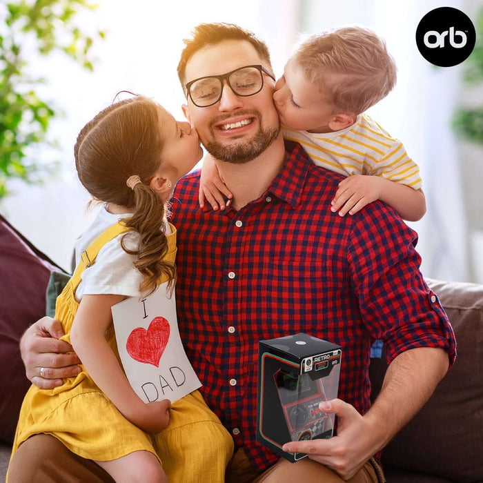 Father hugged by children holding Retro Mini Arcade Racing Game gift.