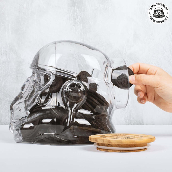 Hand reaching into Original Stormtrooper Cookie Jar filled with cookies, featuring a stylish clear design.