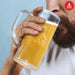 Man drinking from an Official Atari Beer Glass with classic Atari logo, holding 1 pint / 600ml of beer.