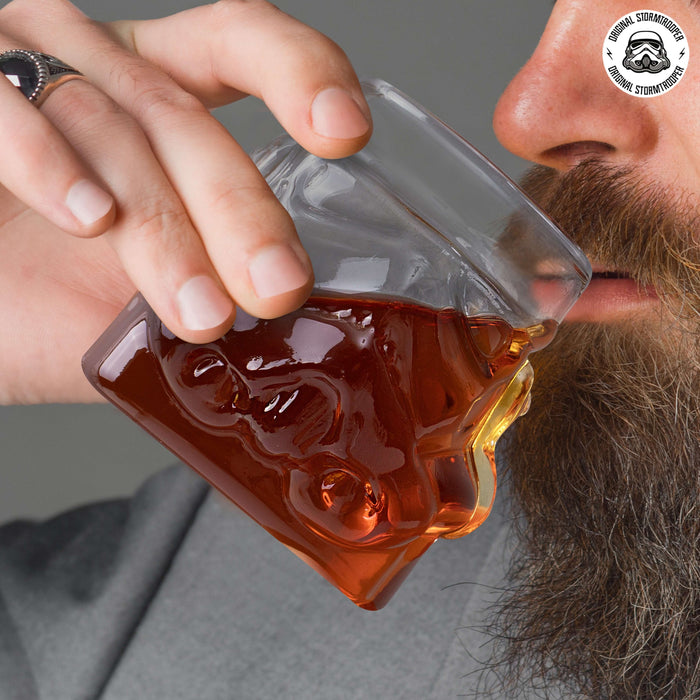 Man drinking whisky from Original Stormtrooper 3D Whisky Glass with iconic Stormtrooper helmet design.