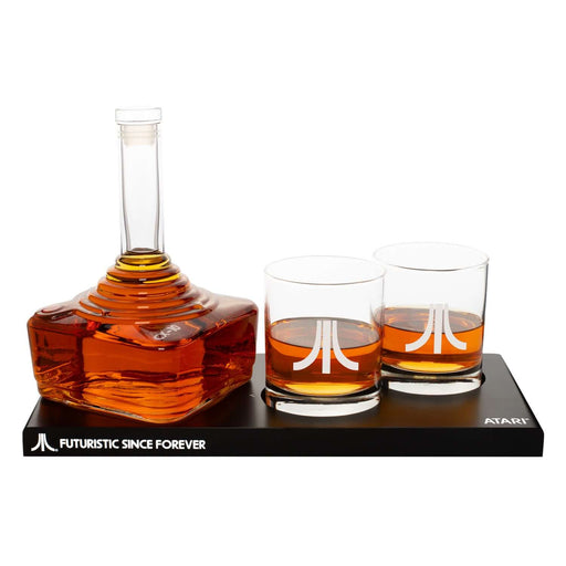 Atari joystick decanter set with CX-10 decanter and two engraved Atari logo glasses on a tray.